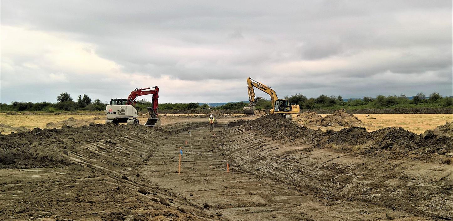 trucks digging in the mud