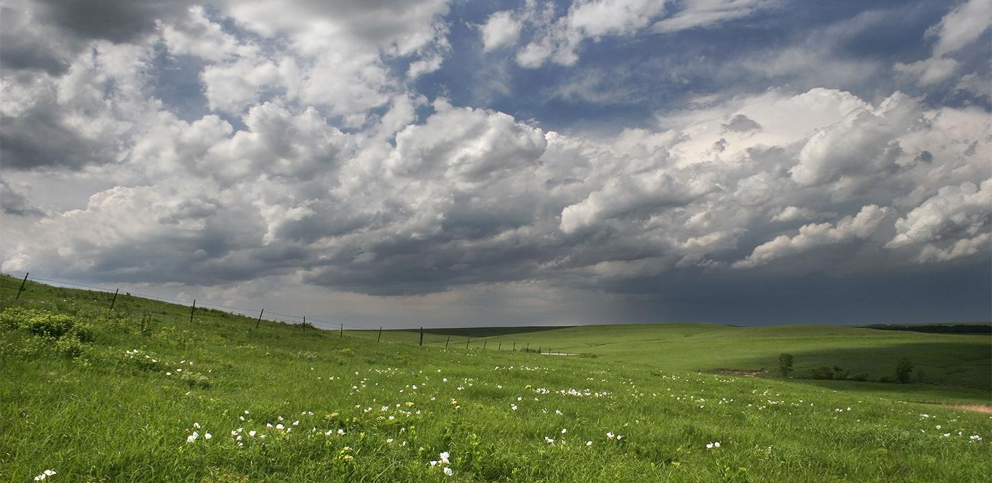 rolling tallgrass prairie hills with moody sky