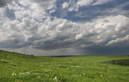 rolling tallgrass prairie hills with moody sky